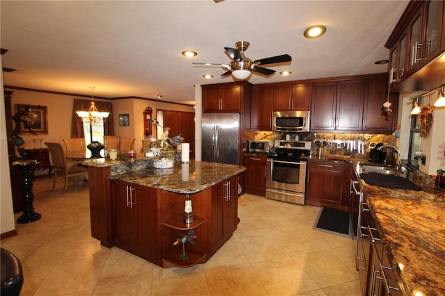 kitchen featuring sink, a center island, hanging light fixtures, dark stone counters, and appliances with stainless steel finishes