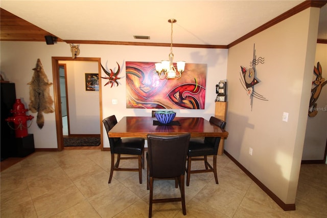 dining area with light tile patterned flooring, ornamental molding, and a chandelier