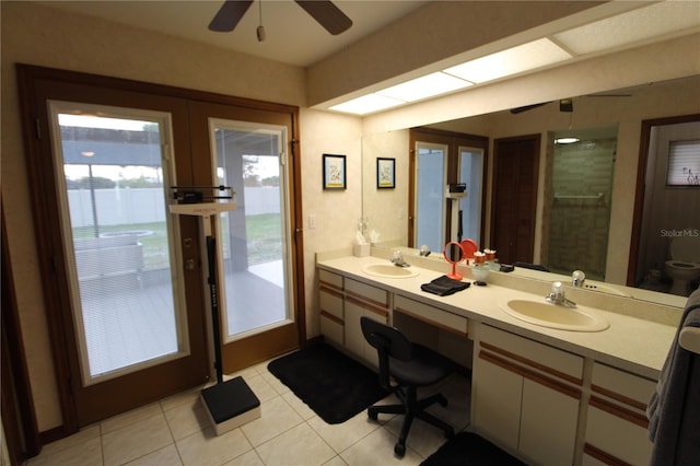 bathroom with ceiling fan, french doors, tile patterned floors, toilet, and vanity