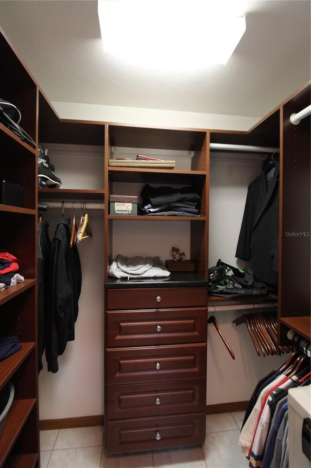 walk in closet featuring light tile patterned flooring