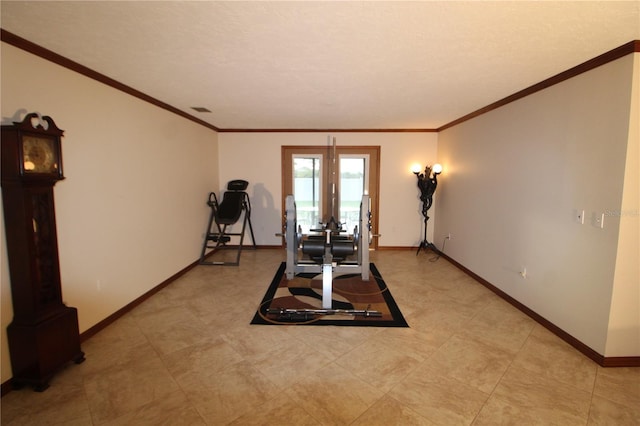 exercise room featuring crown molding