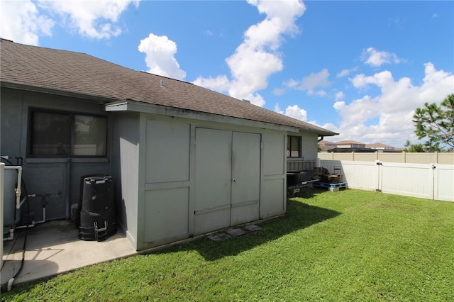 view of outdoor structure featuring a lawn