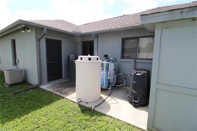 property entrance featuring a lawn and cooling unit