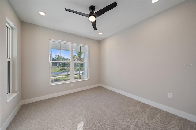 carpeted spare room with ceiling fan