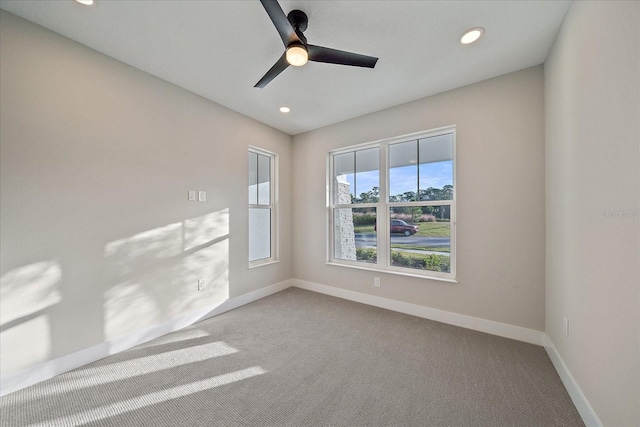 unfurnished room with carpet flooring and ceiling fan