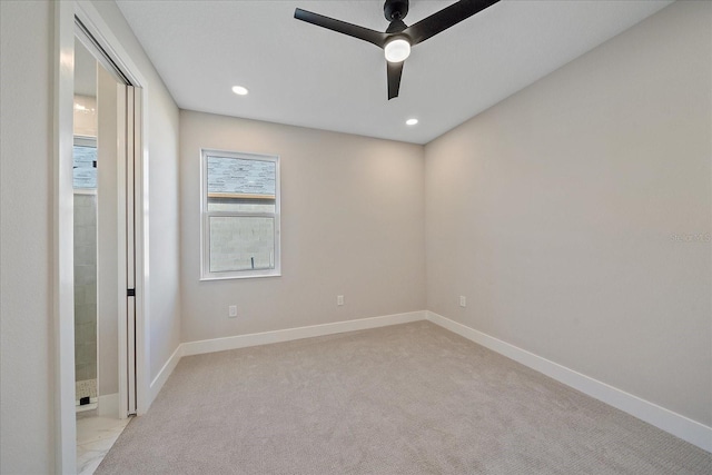 unfurnished room featuring ceiling fan and light colored carpet