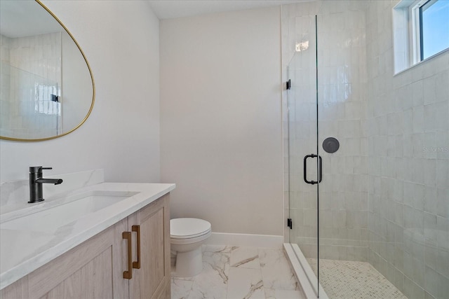 bathroom featuring vanity, a shower with shower door, and toilet