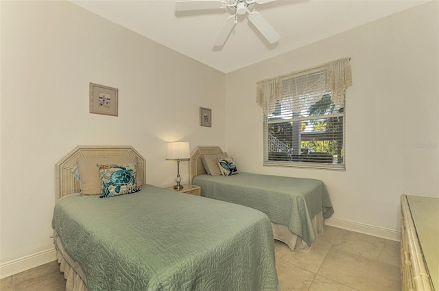 bedroom with ceiling fan and light tile patterned floors