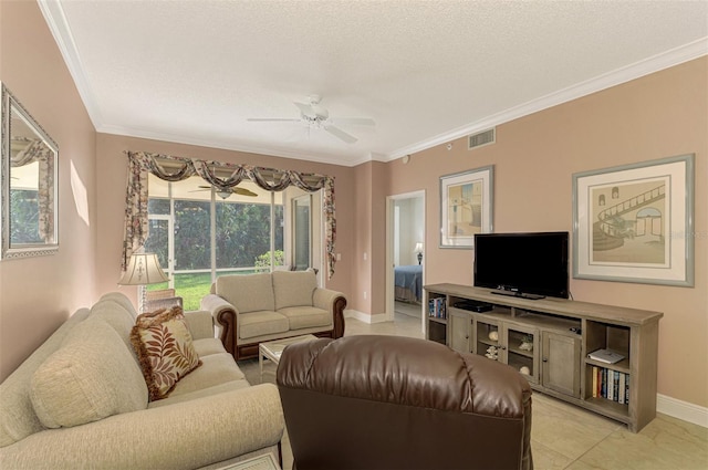 living room featuring ceiling fan, light tile patterned floors, a textured ceiling, and ornamental molding