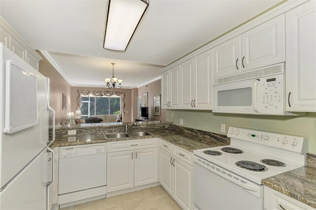 kitchen with white cabinets, white appliances, a chandelier, and sink