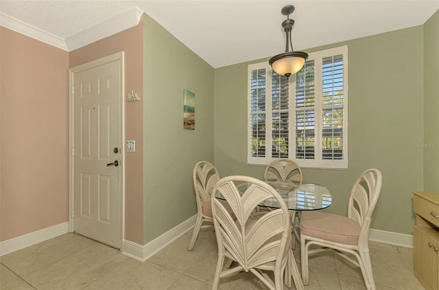 dining area with ornamental molding and light tile patterned flooring