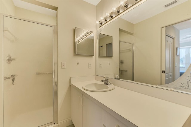 bathroom featuring vanity and a shower with shower door