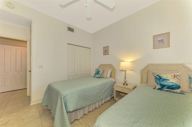 bedroom featuring ceiling fan, light tile patterned flooring, and a closet