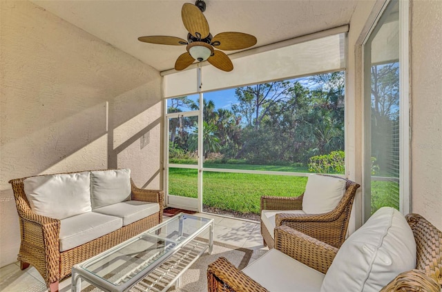 sunroom featuring ceiling fan