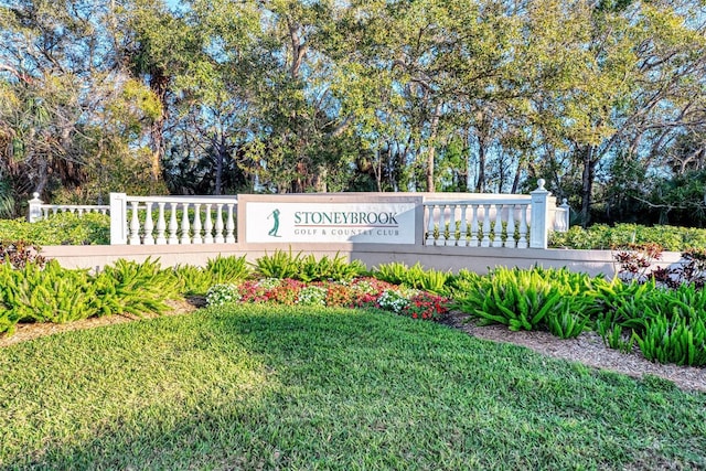 community sign featuring a lawn