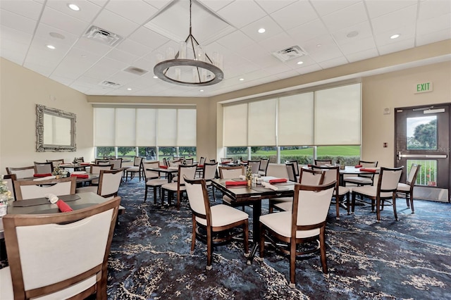 dining space with a paneled ceiling and a wealth of natural light