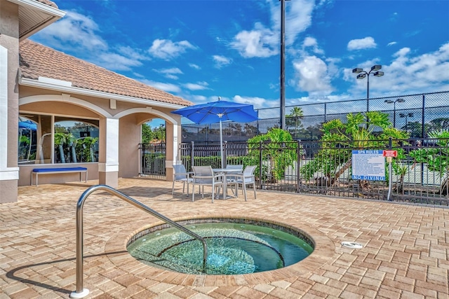 view of swimming pool with a patio and a hot tub