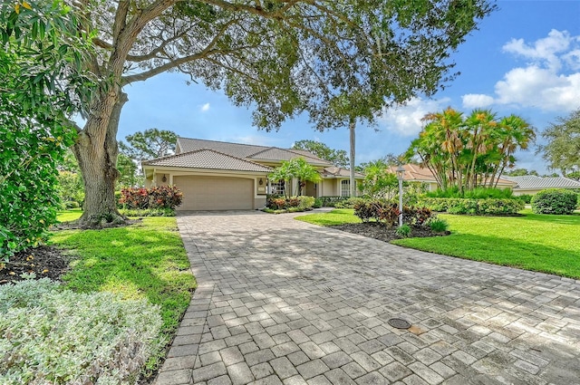 ranch-style house featuring a front yard and a garage