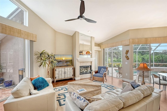 living room with wood-type flooring, high vaulted ceiling, and ceiling fan