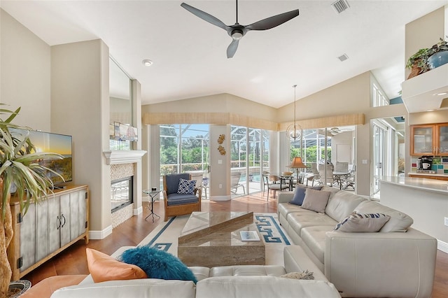 living room featuring hardwood / wood-style floors, high vaulted ceiling, a wealth of natural light, and ceiling fan