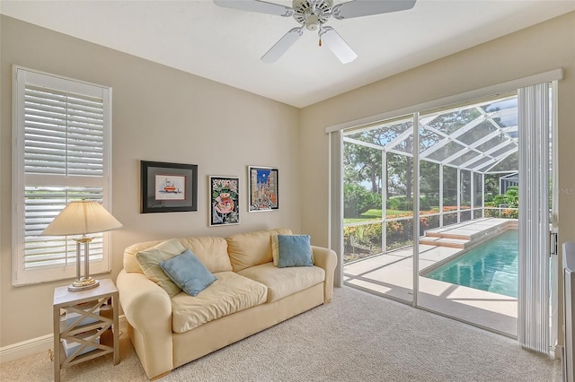 carpeted living room with ceiling fan