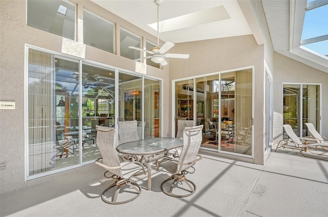 sunroom / solarium featuring beam ceiling and ceiling fan