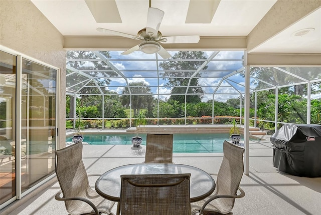 view of swimming pool with glass enclosure, a patio area, and grilling area