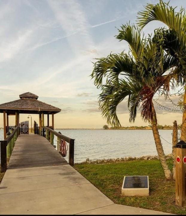 view of dock featuring a gazebo and a water view