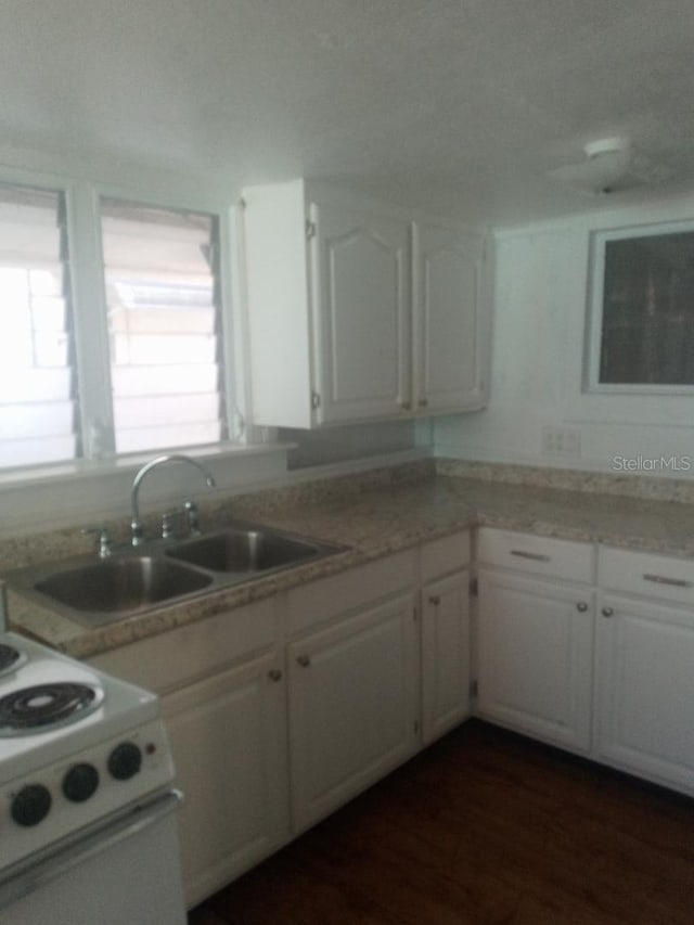5 Palm Ave, Bradenton, FL 34208 - kitchen with white cabinetry, light countertops, a sink, white range, and dark wood finished floors