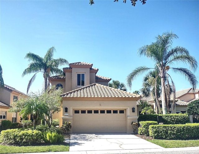 mediterranean / spanish-style home with a garage