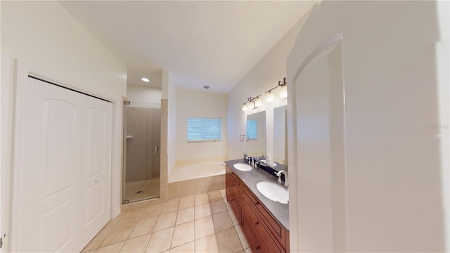 bathroom with tile patterned flooring, vanity, separate shower and tub, and a textured ceiling