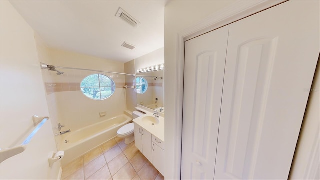 full bathroom featuring tile patterned floors, vanity, toilet, and tiled shower / bath