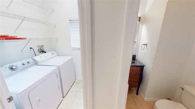 laundry room featuring independent washer and dryer and light tile patterned floors