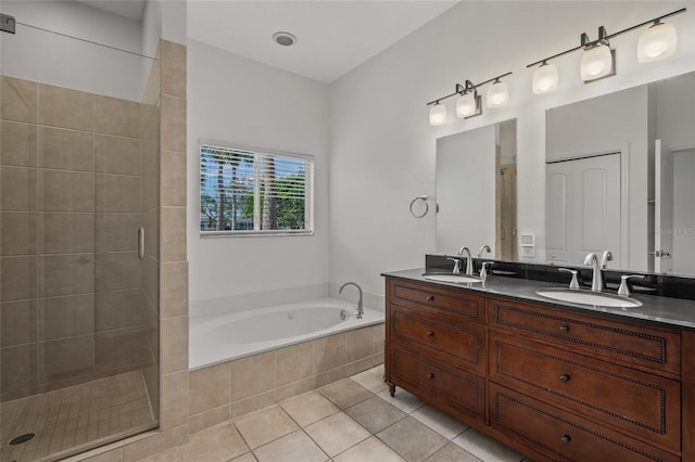 bathroom featuring tile patterned flooring, vanity, and shower with separate bathtub