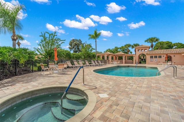 view of pool featuring a patio area and a community hot tub