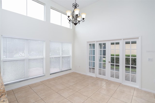 interior space with an inviting chandelier, a healthy amount of sunlight, and light tile patterned flooring