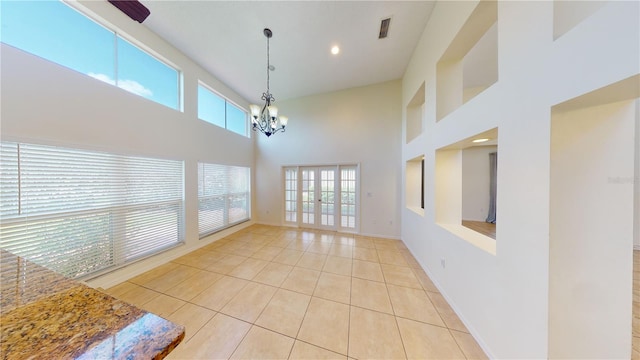 interior space with a high ceiling and a chandelier