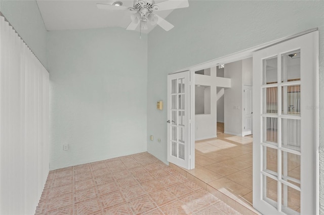 tiled empty room with french doors, vaulted ceiling, and ceiling fan