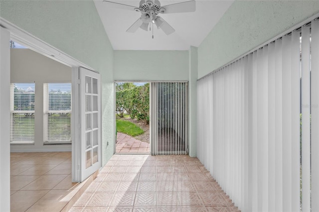 unfurnished sunroom with vaulted ceiling and ceiling fan