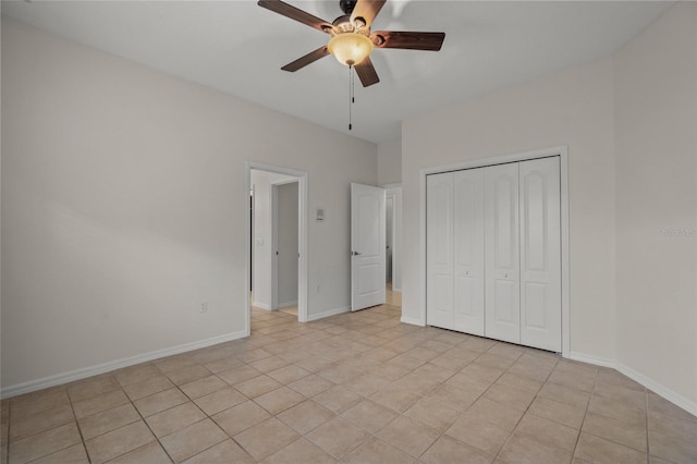 unfurnished bedroom featuring light tile patterned floors, a closet, and ceiling fan