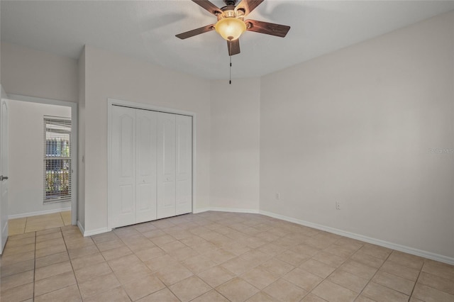 unfurnished bedroom with light tile patterned floors, a closet, and ceiling fan