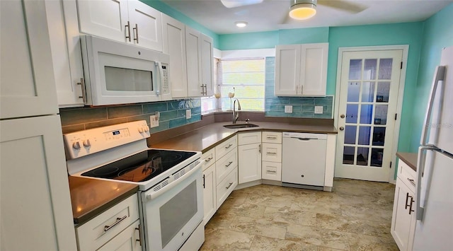 kitchen featuring white cabinets, backsplash, white appliances, and sink