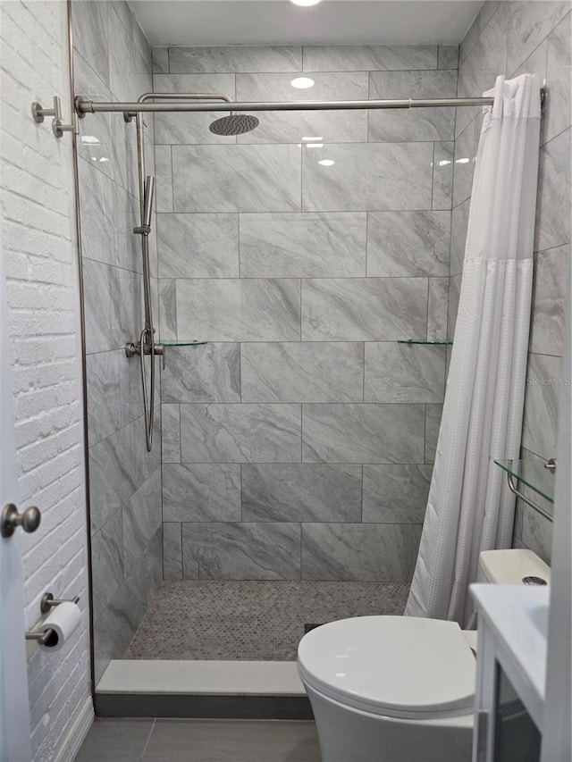 bathroom with curtained shower and toilet