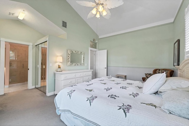 carpeted bedroom with ceiling fan, a closet, and lofted ceiling