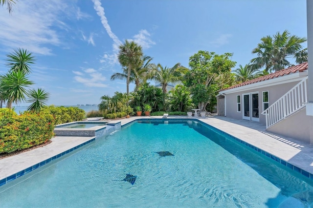 view of pool with a patio area and an in ground hot tub