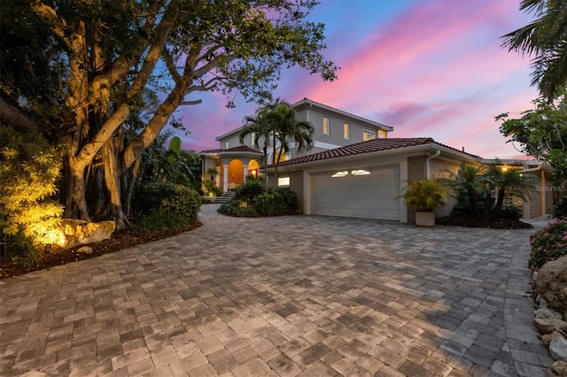 mediterranean / spanish-style home with a garage