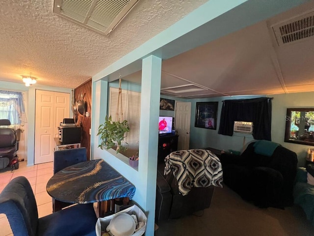 tiled dining area with a textured ceiling