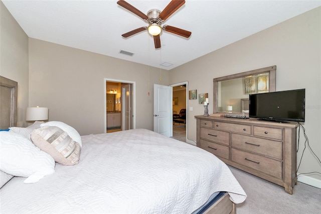 carpeted bedroom with ensuite bathroom and ceiling fan