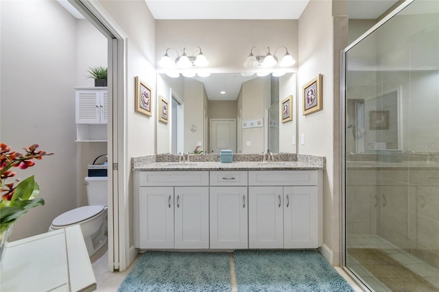 bathroom featuring toilet, vanity, and walk in shower