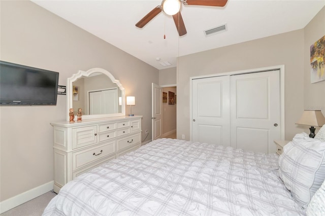 carpeted bedroom with ceiling fan and a closet